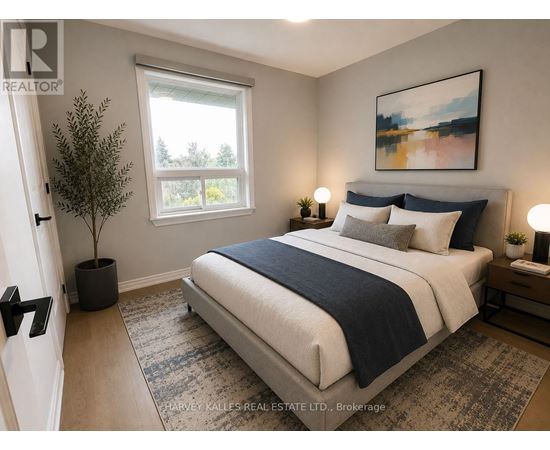 A bedroom with a large bed and a painting on the wall.
