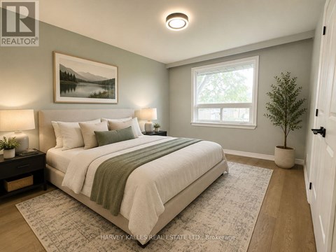 A bedroom with a large bed and a painting on the wall.