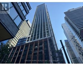 A tall building with the words "Dream Home Realty Inc., Brokerage" on the side.