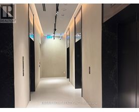 A hallway with doors on both sides and a sign that says "Dream Home Realty Inc., Brokerage.".