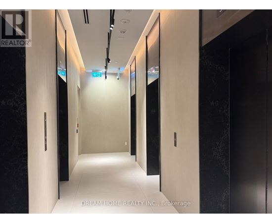 A hallway with doors on both sides and a sign that says "Dream Home Realty Inc., Brokerage.".