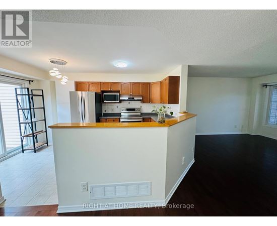 A kitchen with white cabinets and a wooden countertop.