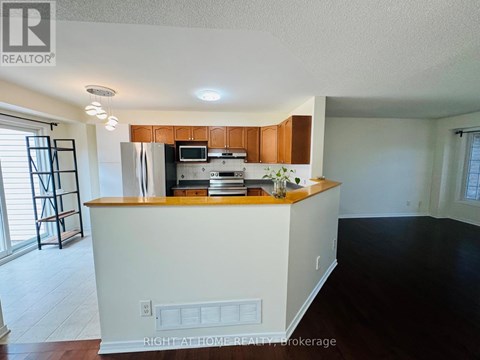 A kitchen with white cabinets and a wooden countertop.