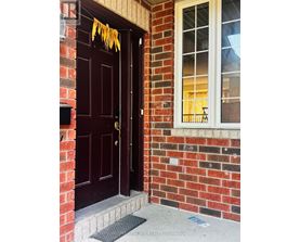 A brown door with a glass window above it.