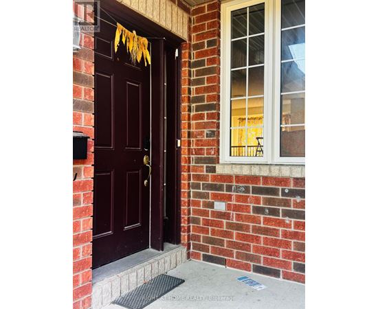 A brown door with a glass window above it.