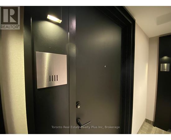 A black door with a silver plate on it.