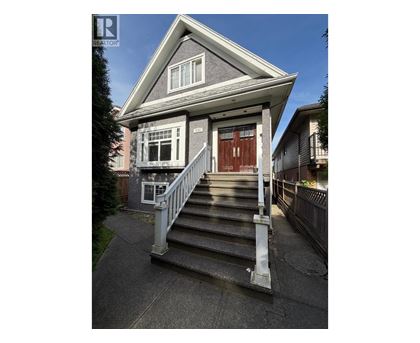 A house with a grey roof and a brown door.