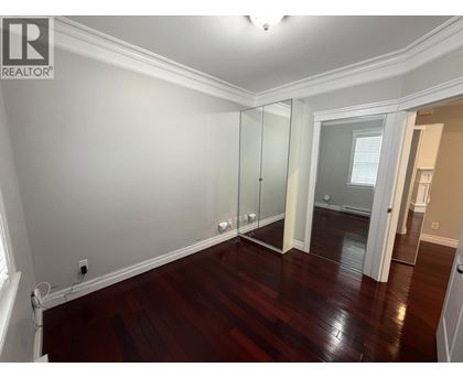 A room with wooden floors and a sliding glass door.