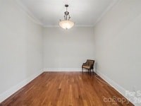 A room with a wooden floor and a chair.