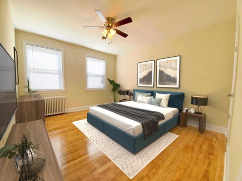 A bedroom with a bed, a ceiling fan, and a window.