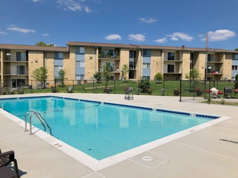 A swimming pool in front of apartment buildings.