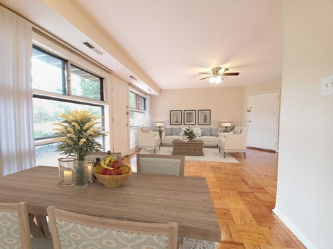 A dining room with a wooden table and chairs.