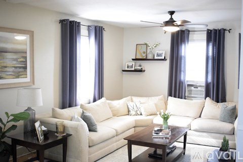 A living room with a white couch and a coffee table.