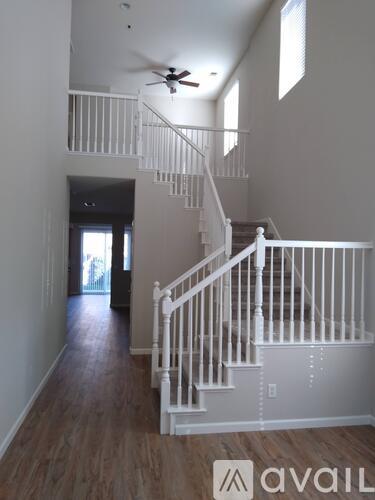 A spacious room with a staircase leading to the upper floor.