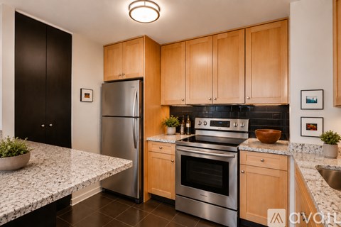 A kitchen with wooden cabinets and a granite countertop.