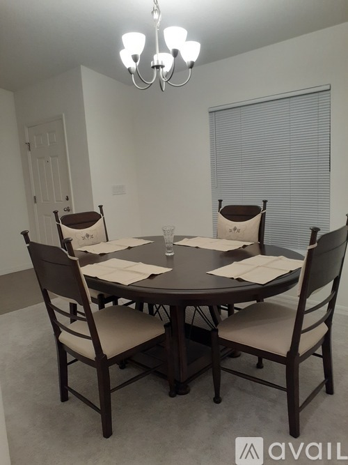 A dining room with a table set for four.
