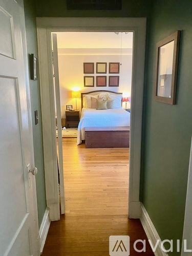 A bedroom with a bed, nightstand, and lamp.