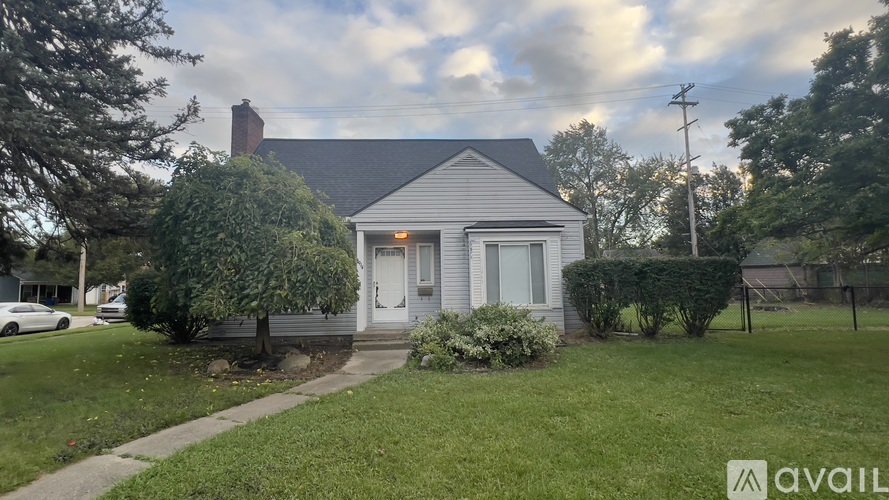 A house with a white door and a small front yard.