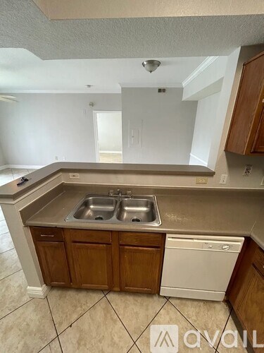 A kitchen with a sink and a dishwasher.