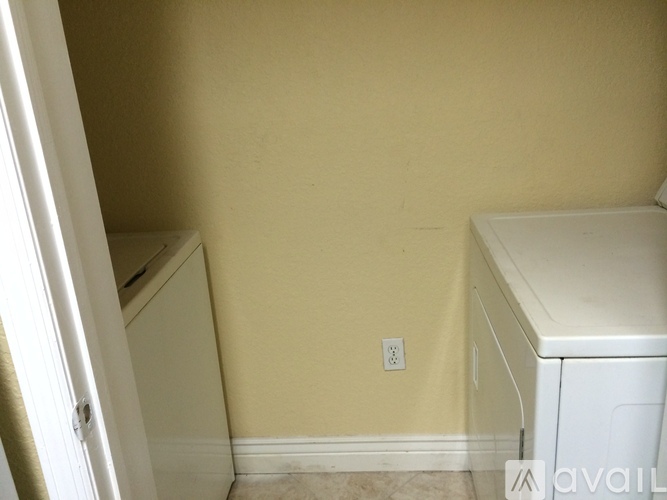 A small laundry room with a washer and dryer.