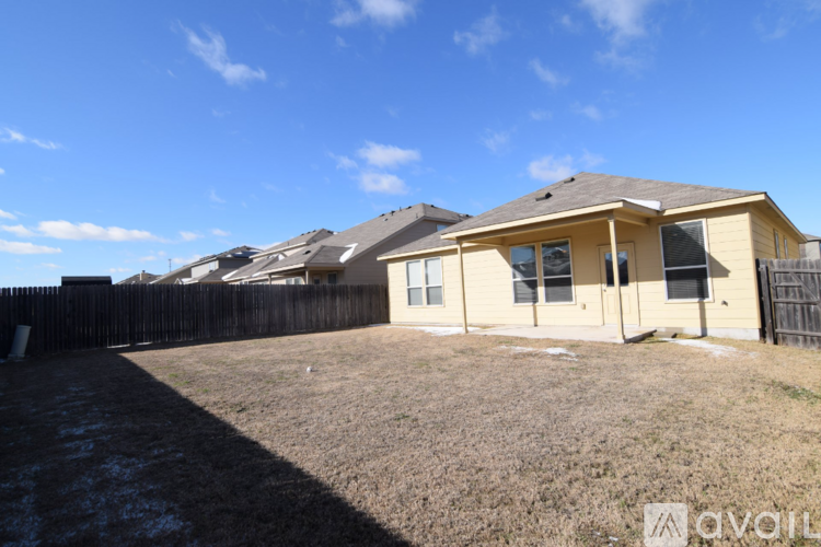 A house with a fence and a grassy yard.