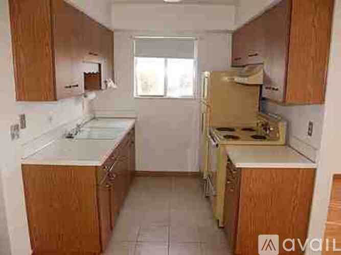 A kitchen with wooden cabinets and a white countertop.