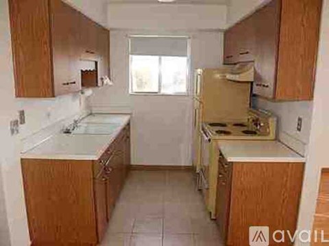 A kitchen with wooden cabinets and a white countertop.
