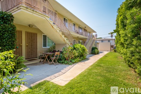 A sunny day at a residential area with a house and a garden.