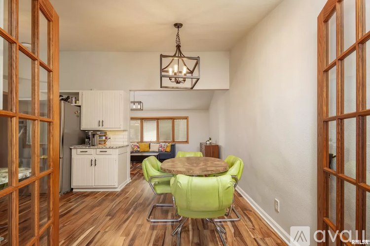 A dining area with a table and chairs.