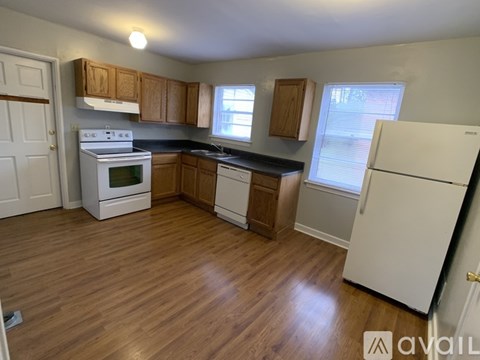A kitchen with a white refrigerator, stove, and oven.
