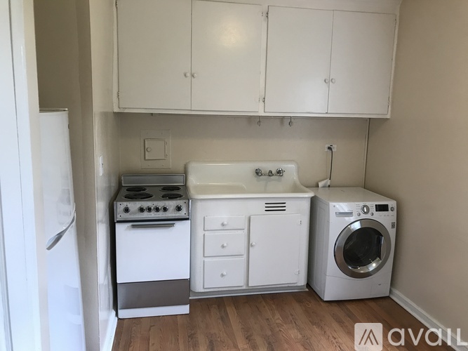 A small kitchen with white appliances and cabinets.