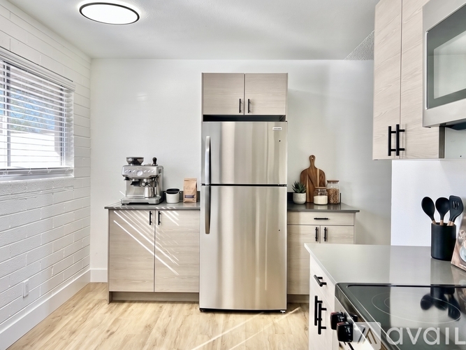 A modern kitchen with a stainless steel refrigerator and wooden cabinets.