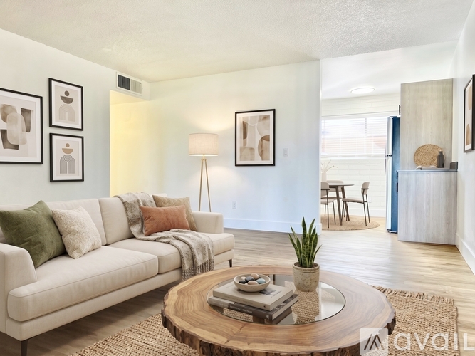 A living room with a white couch and a wooden coffee table.