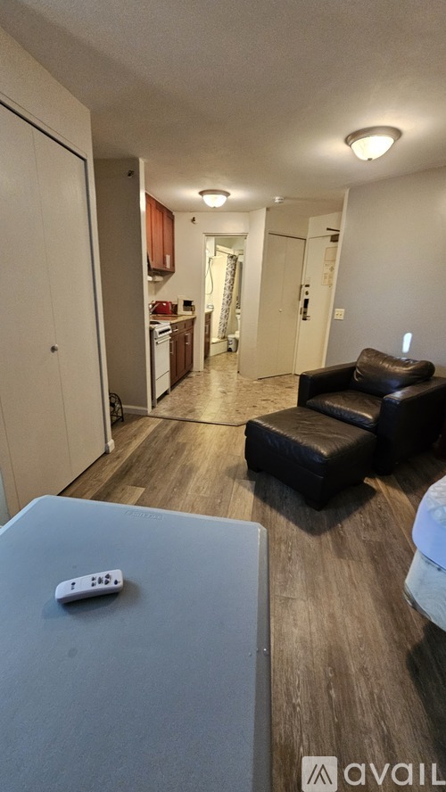 A living room with a couch and a remote control on the table.