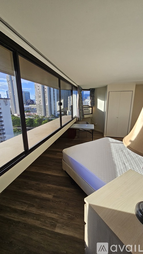 A bedroom with a large bed and a view of the city.