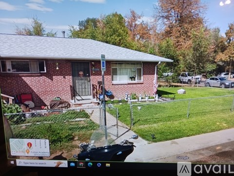 A house with a red brick exterior and a white window is shown on a Google Maps street view.