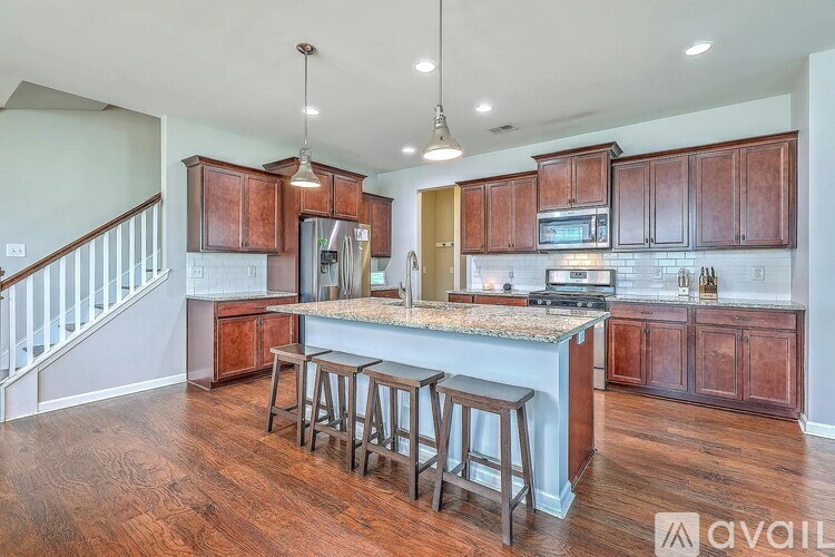 A kitchen with wooden cabinets and a granite countertop.