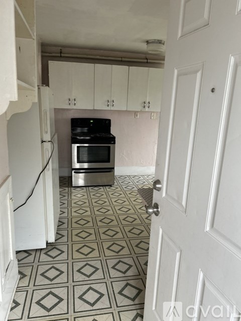A kitchen with a stove and a refrigerator.
