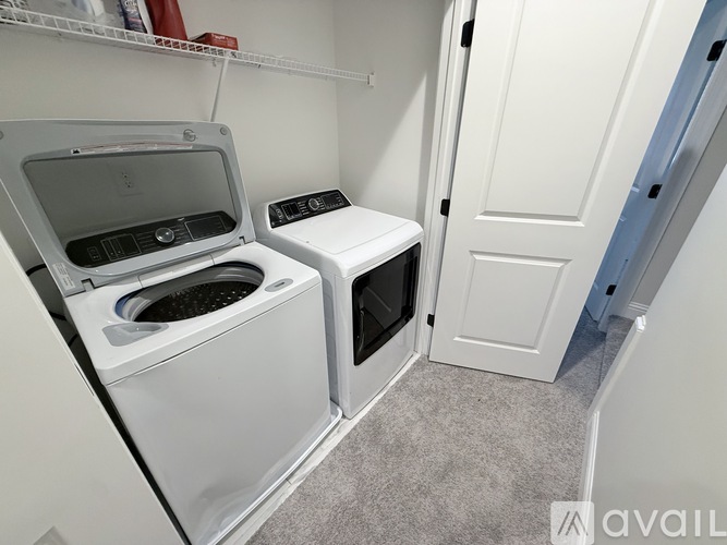 A small laundry room with a washer and dryer.