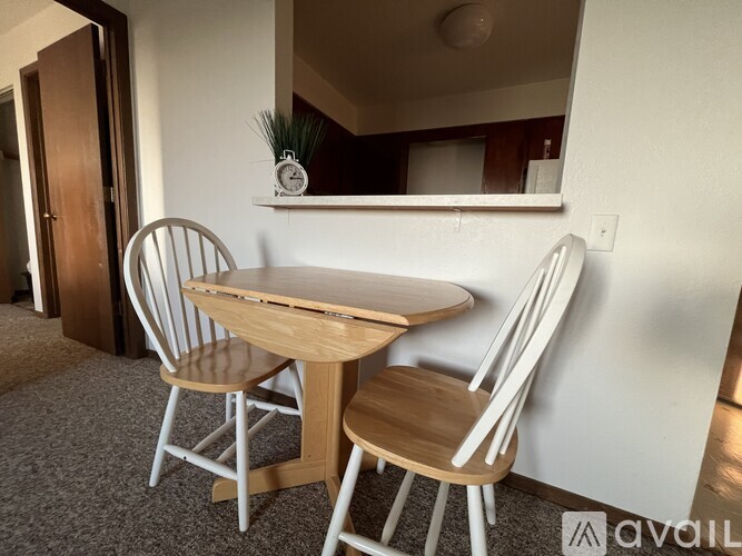 A dining table with two chairs in a room.