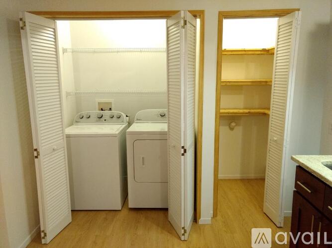 A small laundry room with a washer and dryer.