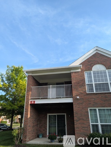 A brick building with a balcony and a window.