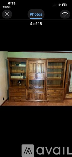 A wooden cabinet with glass doors and shelves.
