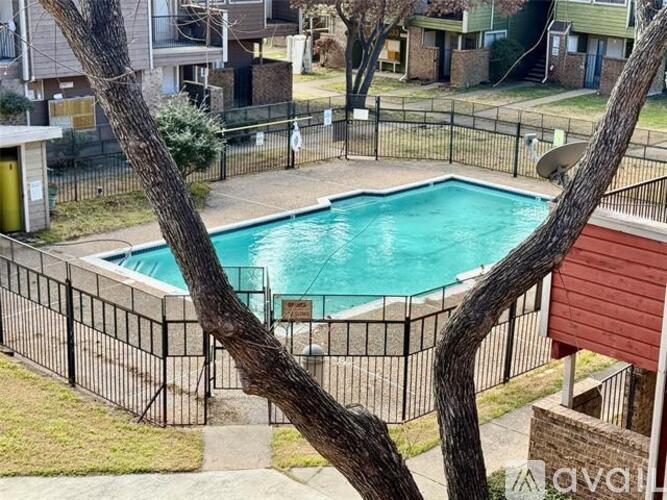A small pool surrounded by a black fence.