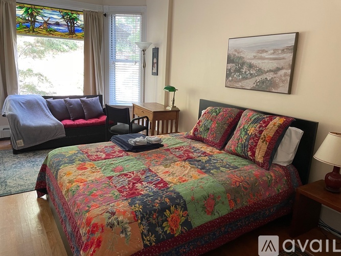 A bedroom with a large bed and a couch.
