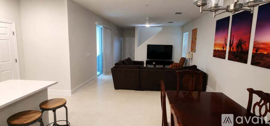 A living room with a brown couch and a television.