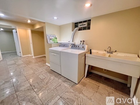 A kitchen with a washing machine and a sink.