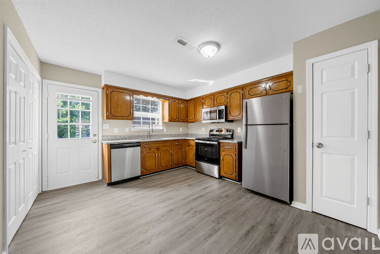 A kitchen with wooden cabinets and stainless steel appliances.