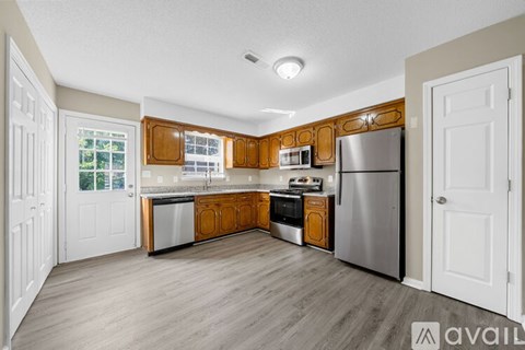 A kitchen with wooden cabinets and stainless steel appliances.