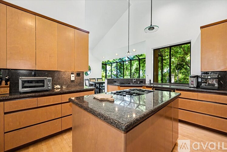 A kitchen with wooden cabinets and a granite countertop.